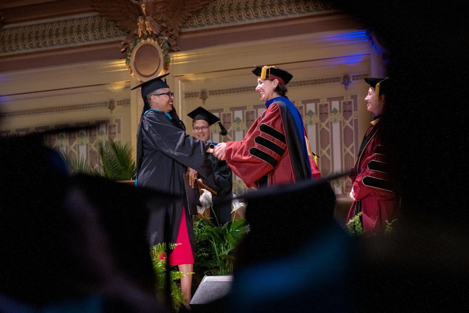 "Student shakes Dean Slotterback's hand at graduation"