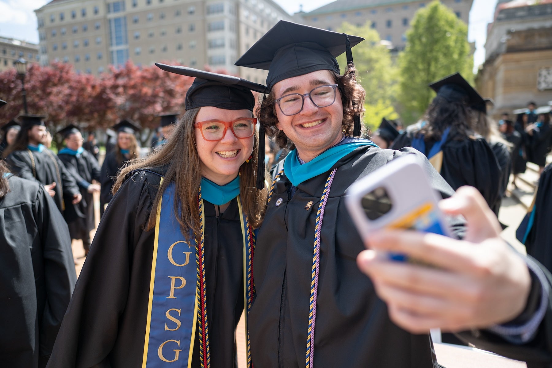 Students take a selfie at graduation