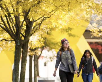 Student walking outside of Posvar Hall 