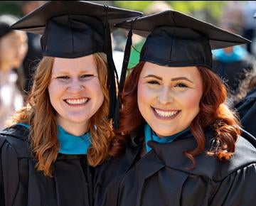 two female grads together